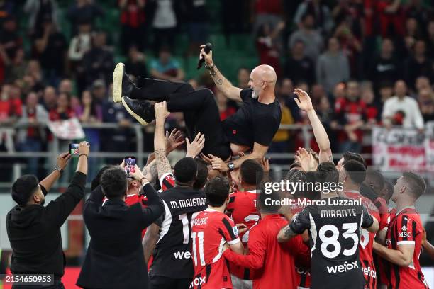 Stefano Pioli, Head Coach of AC Milan, is thrown in the air by his players after the Serie A TIM match between AC Milan and US Salernitana at Stadio...