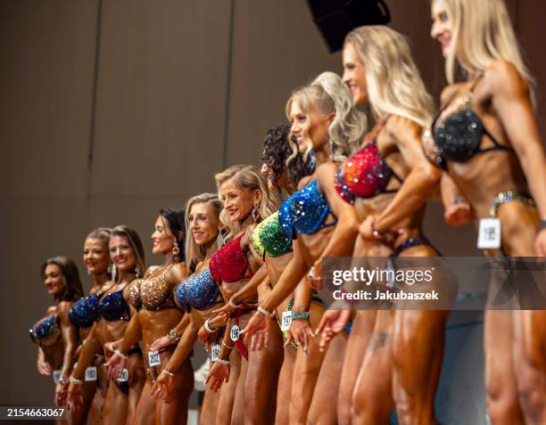 Female competitors pose on stage during the German Body Building Championships on May 25, 2024 in Wiesloch, Germany.