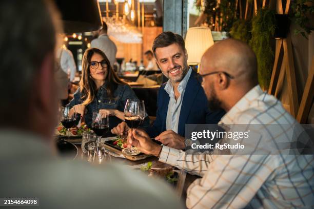 multiracial business team enjoying at the restaurant - upper class stock pictures, royalty-free photos & images