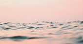 Close Up Ripples And Texture Of Ocean Surface At First Light With Pink ...