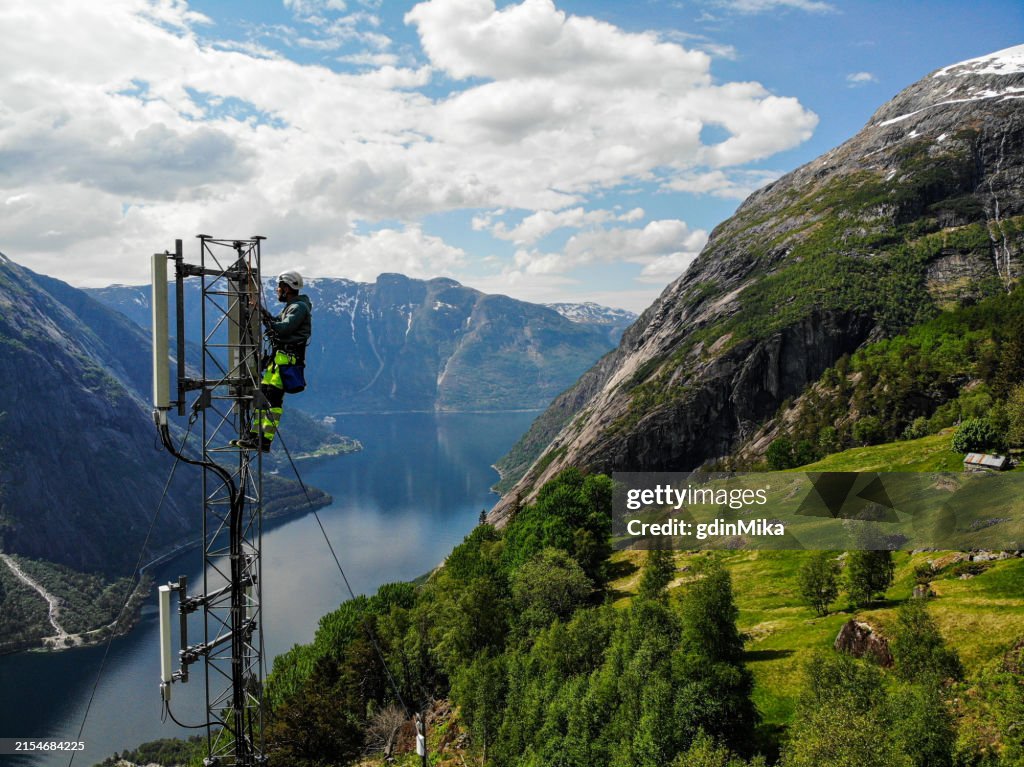 Telecommunication tower and mast installations antenna with 5G, 4G LTE, 3G UMTS, GSM, DCS bands stock photo taken by drone in Scandinavia