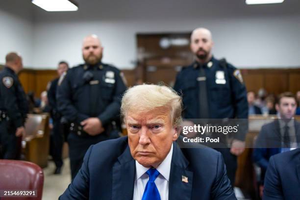 Former U.S. President Donald Trump sits at the defendant's table inside the courthouse as the jury is scheduled to continue deliberations for his...