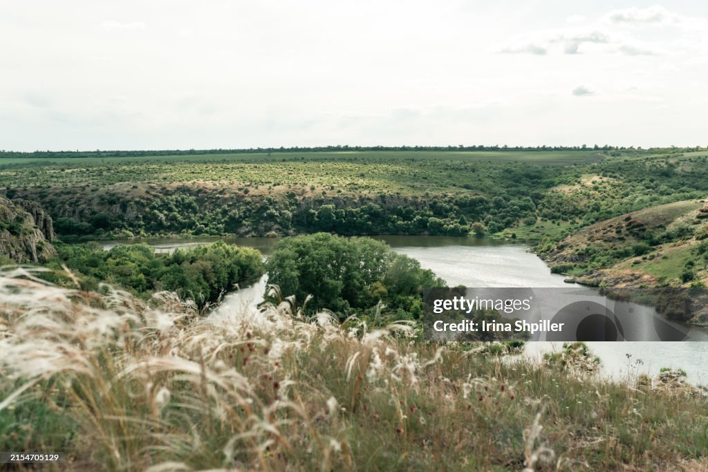 Beautiful natural scenery of river in Ukraine with rocks in background, top view. Summer time.