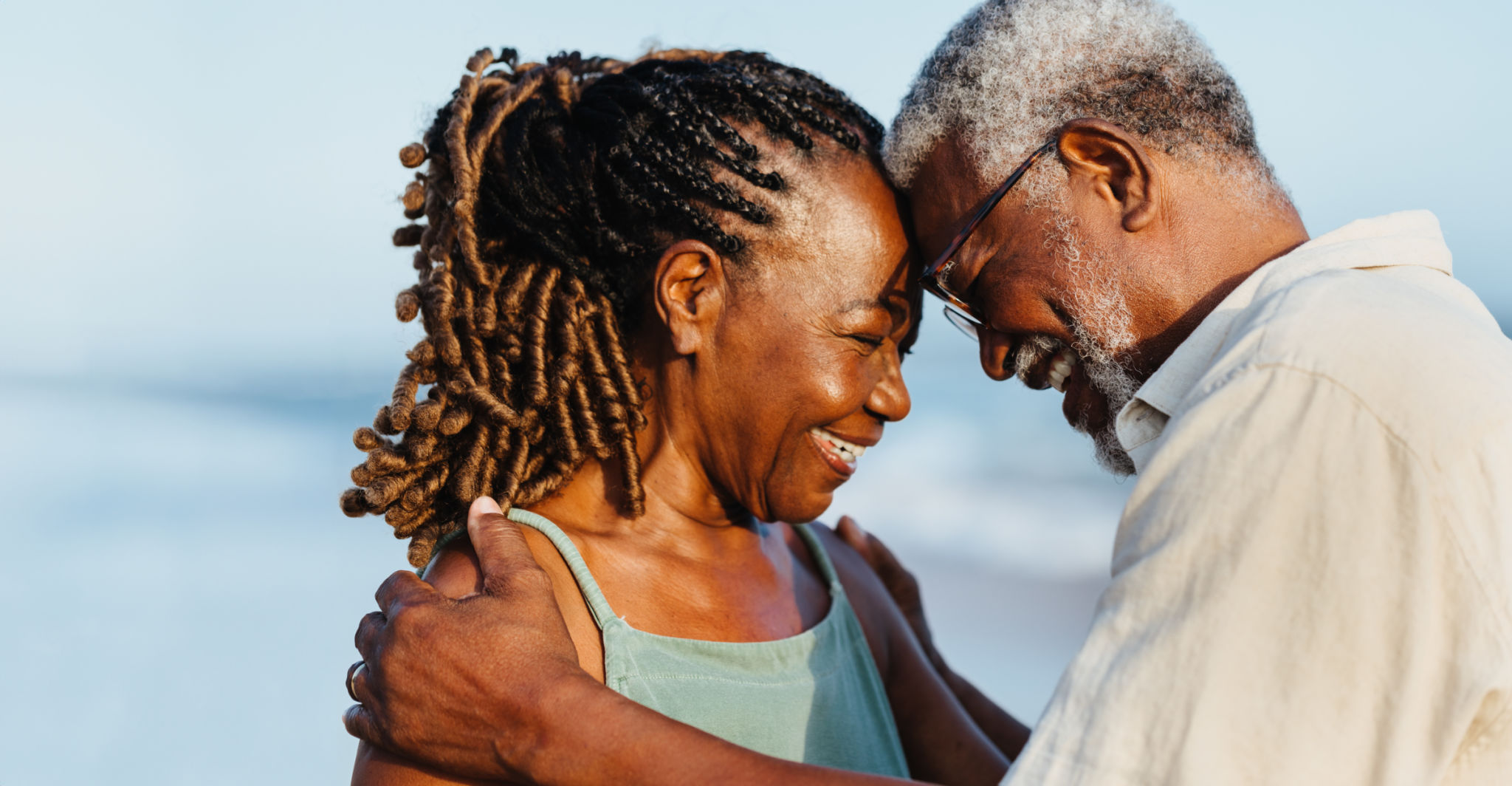Elderly African American couple shares a joyful moment on the beach Elderly African American couple shares a joyful moment on the beach