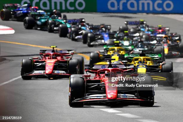 Charles Leclerc of Monaco driving the Ferrari SF-24 leads Oscar Piastri of Australia driving the McLaren MCL38 Mercedes and Carlos Sainz of Spain...
