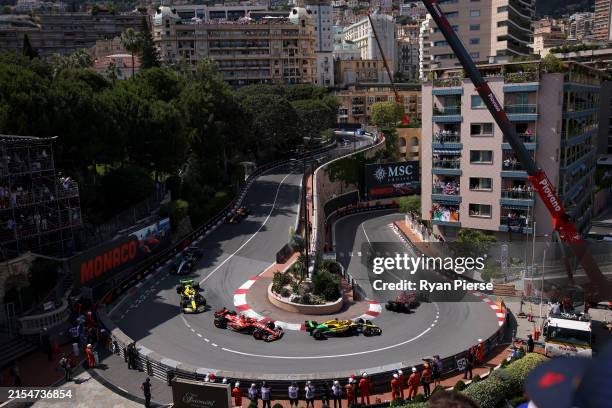 Charles Leclerc of Monaco driving the Ferrari SF-24 leads Oscar Piastri of Australia driving the McLaren MCL38 Mercedes, Carlos Sainz of Spain...
