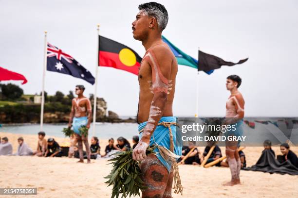 Australian Indigenous performers adorned in traditional body paint stand on Coogee Beach as they prepare to perform in the annual Koojay Corroboree...