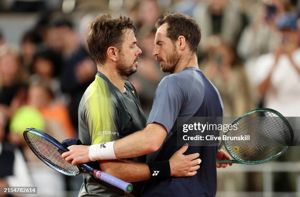 Stan Wawrinka of Switzerland and Andy Murray of Great Britain embrace at the net after their Men's Singles First Round match on Day One of the 2024...