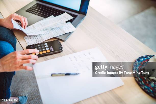 young woman managing home budget with digital tools at home. - budget stock pictures, royalty-free photos & images