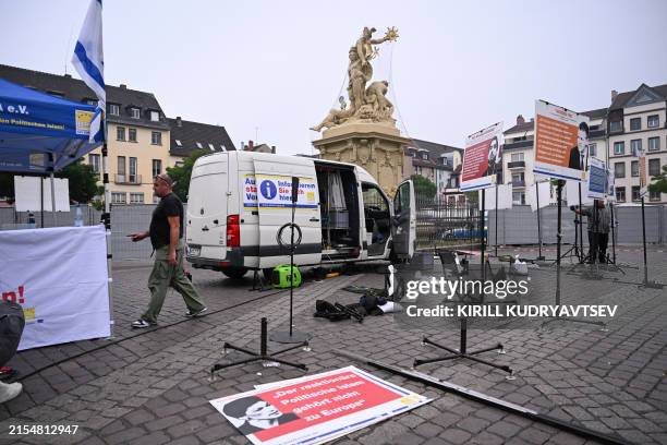 Workers clean up the scene where several people were injured in a knife attack on May 31, 2024 in Mannheim, western Germany. Media reported that a...