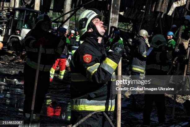 Firefighters remove rubble from destroyed hypermarket after Russian attack with aerial bombs on May 27, 2024 in Kharkiv, Ukraine. According to the...