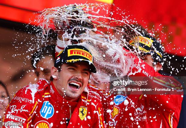 Race winner Charles Leclerc of Monaco and Ferrari and Third placed Carlos Sainz of Spain and Ferrari celebrate on the podium during the F1 Grand Prix...
