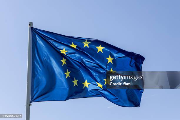 european unsion - eu-flag in the blue sky - europaflagge stock-fotos und bilder