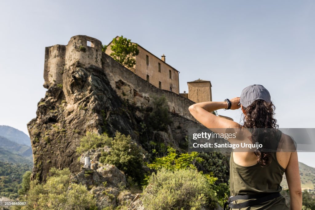 Woman looking at the Citadel of Corte
