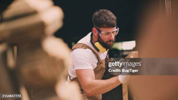 ้handsome carpenter working in carpentry workshop. - timmerman stockfoto's en -beelden