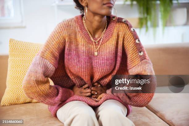gen z young woman sufering stomach ache - abdomen stock pictures, royalty-free photos & images