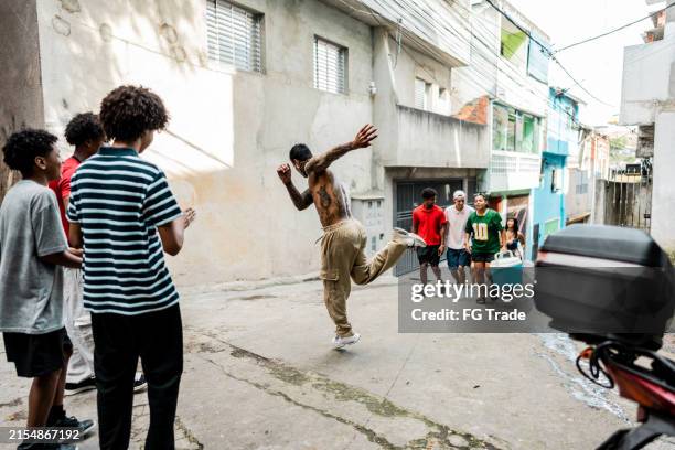 friends arriving while man is dancing in the street in favela, brazil - funk music stock pictures, royalty-free photos & images