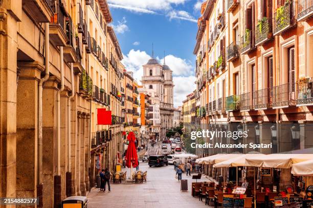 sunny street in madrid old town, spain - madrid stockfoto's en -beelden