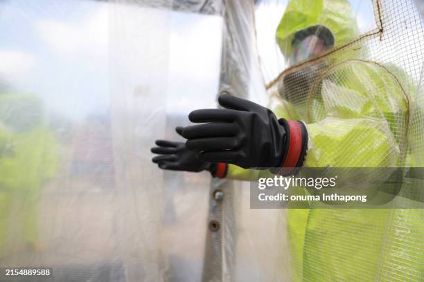 portrait hazmat rescue, rescuers emergency response teams wearing hazmat suits conduct disaster preparedness drills. safety man wearing a hazmat suit working on violet area - hazardous substances stock pictures, royalty-free photos & images
