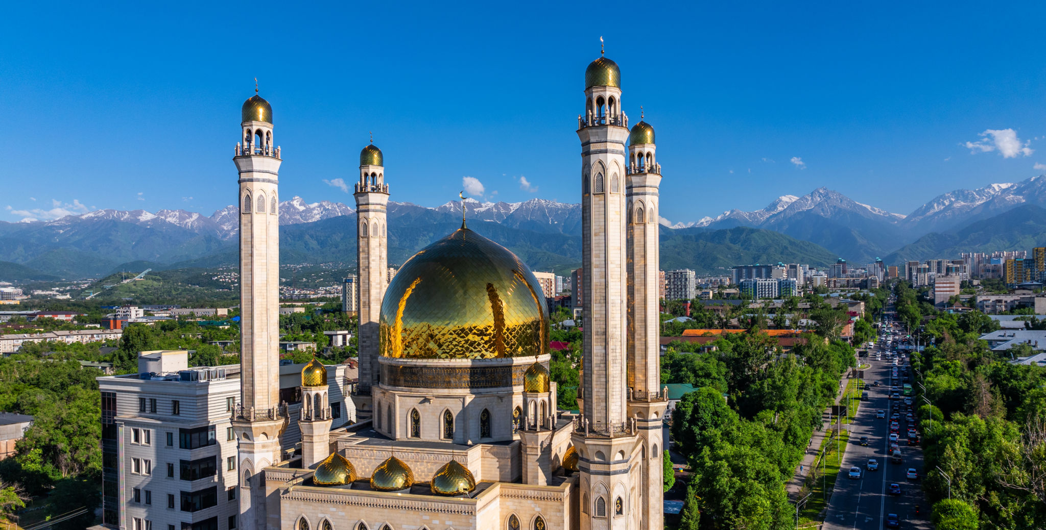 A mosque in the Kazakh city of Almaty against the backdrop of a mountain range on a spring day A mosque in the Kazakh city of Almaty against the backdrop of a mountain range on a spring day