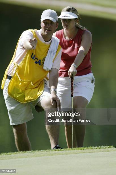 Hilary Lunke and her caddie/husband Tylar look over the putting green during the 18 hole playoff of the U.S. Women's Open on July 7, 2003 at Pumpkin...