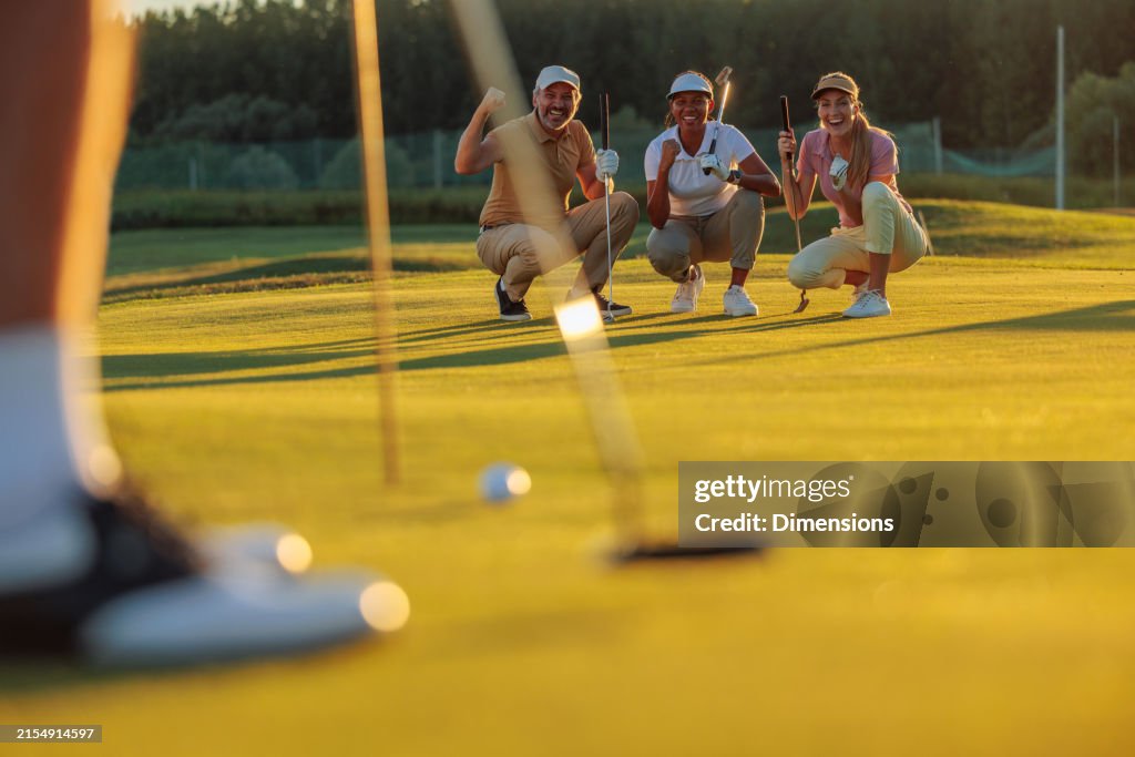 Person putting a ball in front of their friends