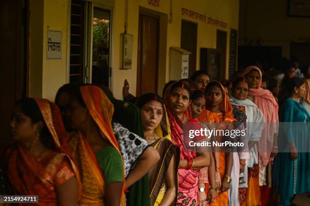 Women are standing in a queue at a polling station to cast their votes during the seventh and final phase of the Indian General Elections in...