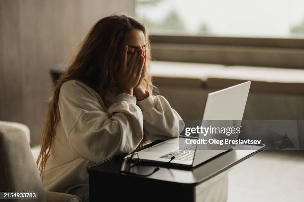 tired woman in depression after problems with online business. working on laptop. - broken heart stock pictures, royalty-free photos & images