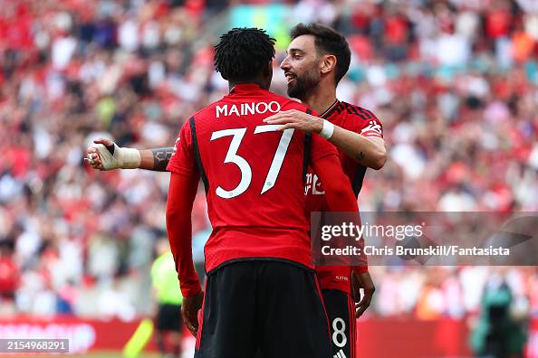 Mainoo Sad Kobbie Mainoo of Manchester United is congratulated by team-mate ...