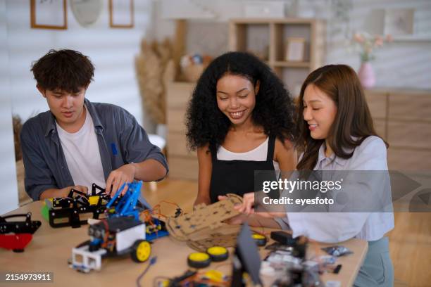 group of college students are developing their machinery project. - plastic model kit stock pictures, royalty-free photos & images