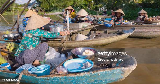 vietnamese woman preparing coconut's snacks, floating market, mekong river delta, vietnam - coconut geranium stock pictures, royalty-free photos & images