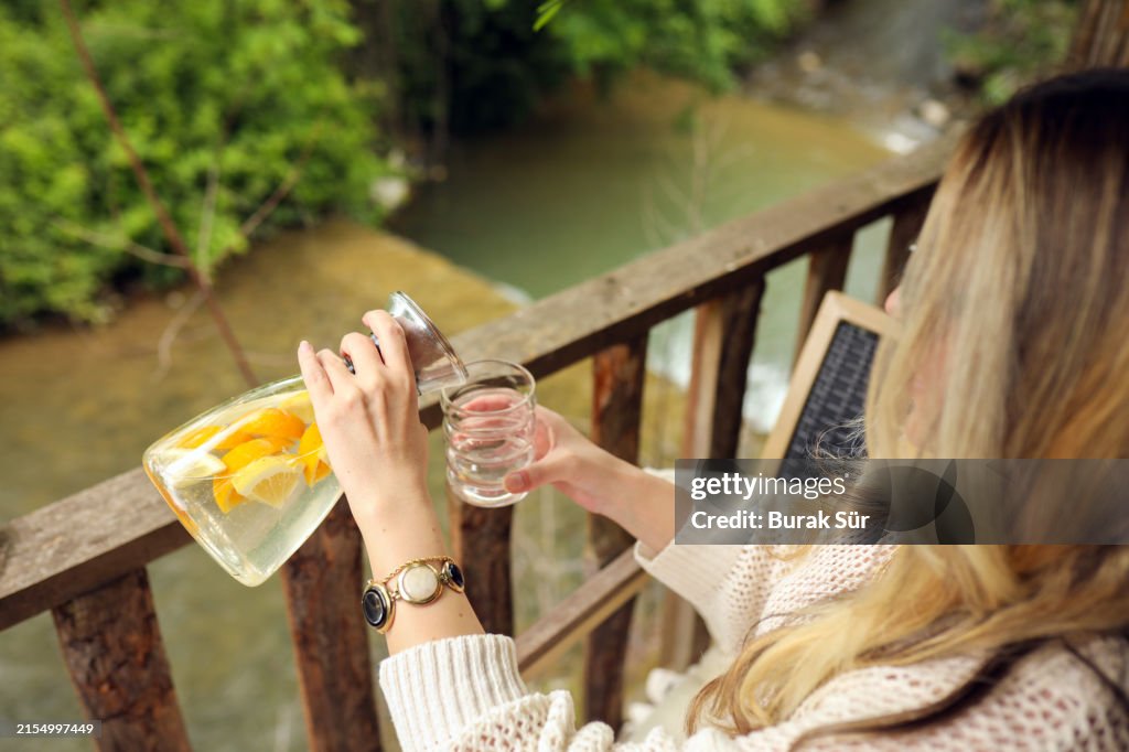 Young Woman Consuming Detox Water, Healthy Living and Water Consumption