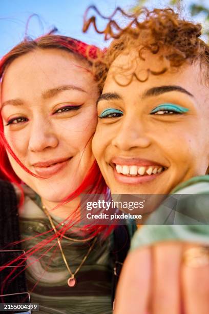 close-up of two gen z adults smiling and laughing outdoors. urban environment. friendship and well-being. - gender identity stock pictures, royalty-free photos & images