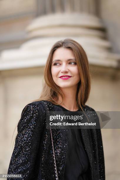Segolene Hyppolite wears neon pink lipstick, make-up a black sequined shiny oversize blazer jacket from La Petite Etoile Paris, a black lustrous...