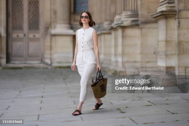 Marissa Cox wears a white Arket linen skirt set, a sleeveless long top with buttons, a brown raffia Loewe basket bag, ATP Atelier brown suede sandals...