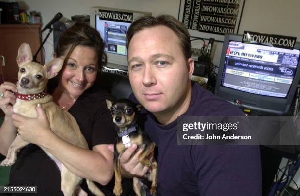 Portrait of American couple, animal activist Kelly Rebecca Nichols and television & radio host and conspiracy theorist Alex Jones, each a holding a...