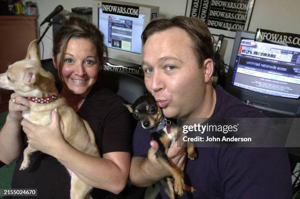Portrait of American couple, animal activist Kelly Rebecca Nichols and television & radio host and conspiracy theorist Alex Jones, each a holding a...