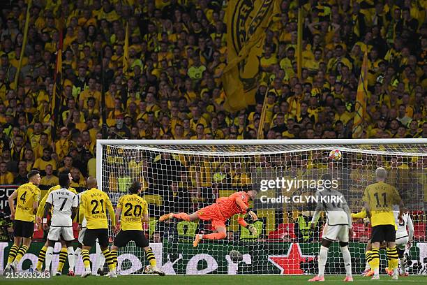 Real Madrid's Brazilian forward Vinicius Junior scores his team's second goal during the UEFA Champions League final football match between Borussia...
