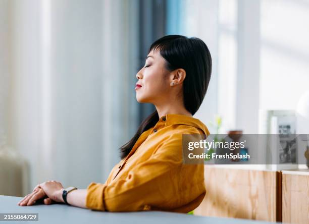 woman relaxing with eyes closed in office environment - självreflektion bildbanksfoton och bilder