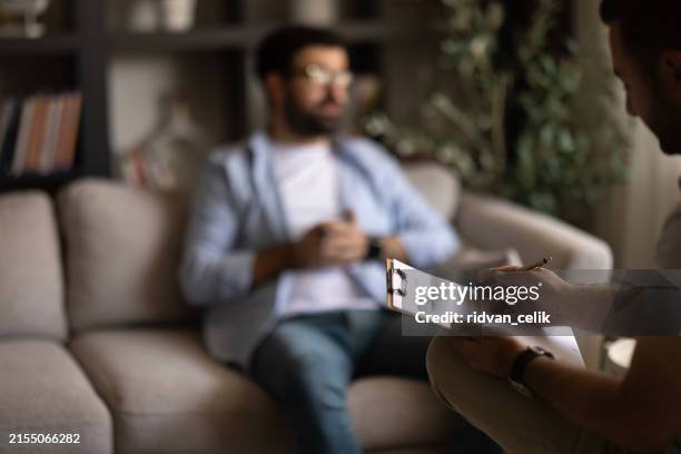doctor talks with patient and takes notes - psychiatrists couch stock pictures, royalty-free photos & images