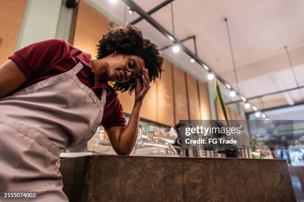 worried young waitress working at cafeteria - angry waitress stock pictures, royalty-free photos & images