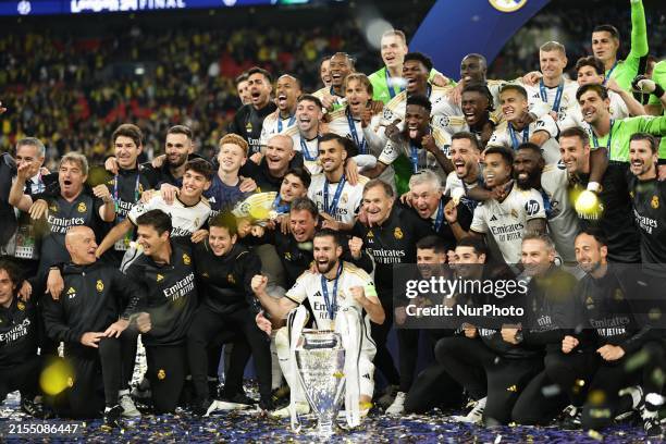 Real Madrid players are celebrating with the trophy after the UEFA Champions League Final match between Real Madrid and Borussia Dortmund at Wembley...