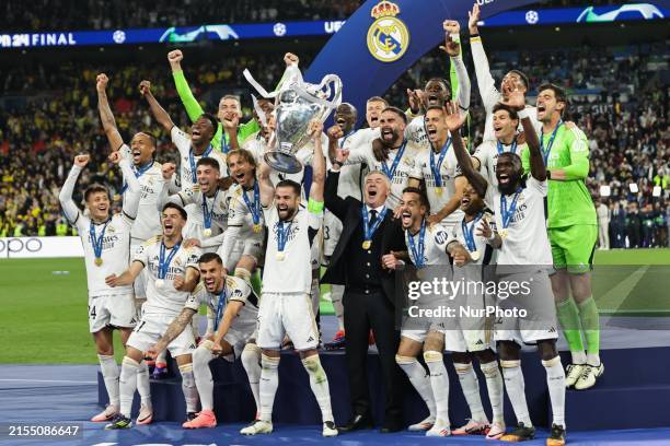 Real Madrid players are celebrating with the trophy after the UEFA Champions League Final match between Real Madrid and Borussia Dortmund at Wembley...