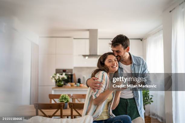 young couple drinking morning coffee enjoying the weekend in their new apartment - proprietario di casa foto e immagini stock