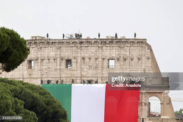 Firefighters set an Italian tricolor flag on the Colosseum the occasion of the Italian Republic Day in Rome, Italy, on June 02, 2024. Italy...