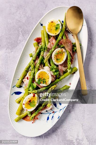 asparagus with soft boiled eggs and prosciutto - asparagus stock pictures, royalty-free photos & images