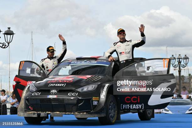 Second placed France's Citroen pilot Sebastien Ogier and co-pilot Vincent Landais celebrate on the podium of the Rally of Sardegna, 5th round of the...