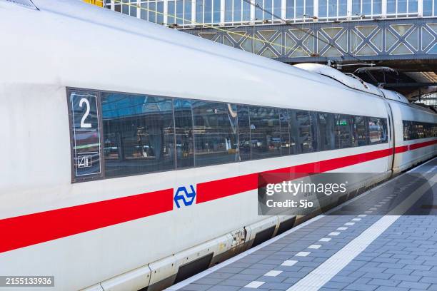 ice -intercity express- high speed train arriving in amsterdam - deutsche bahn stock-fotos und bilder