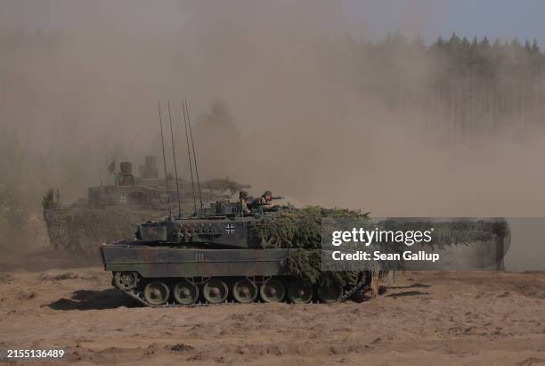 Leopard 2A6 main battle tanks of the Bundeswehr, the German armed forces, participate in the Quadriga military exercises involving German, French,...