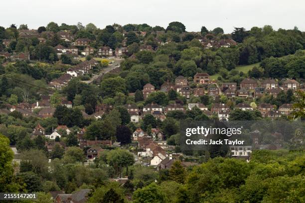 Homes stand dotted among the trees on June 02, 2024 in West Wycombe, United Kingdom. West Wycombe, situated in the parliamentary constituency of...